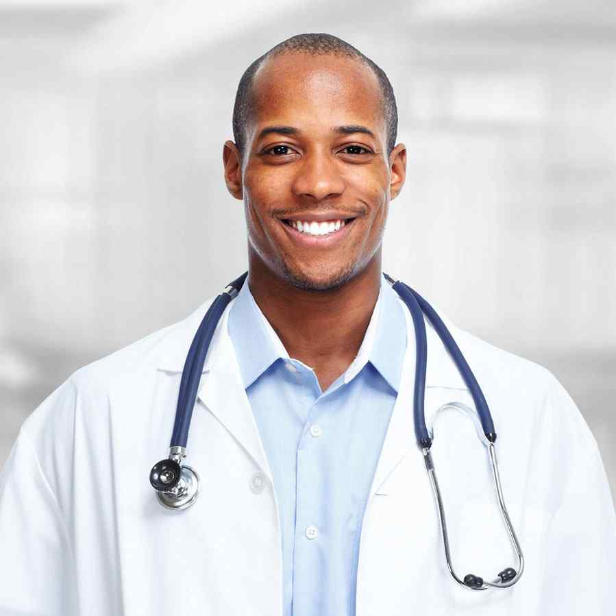 Smiling male doctor with stethoscope in a professional setting.