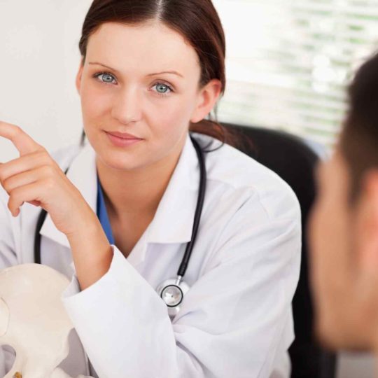 A female doctor consulting a patient in a bright office.