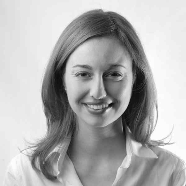 Black-and-white portrait of a smiling young woman with shoulder-length hair.