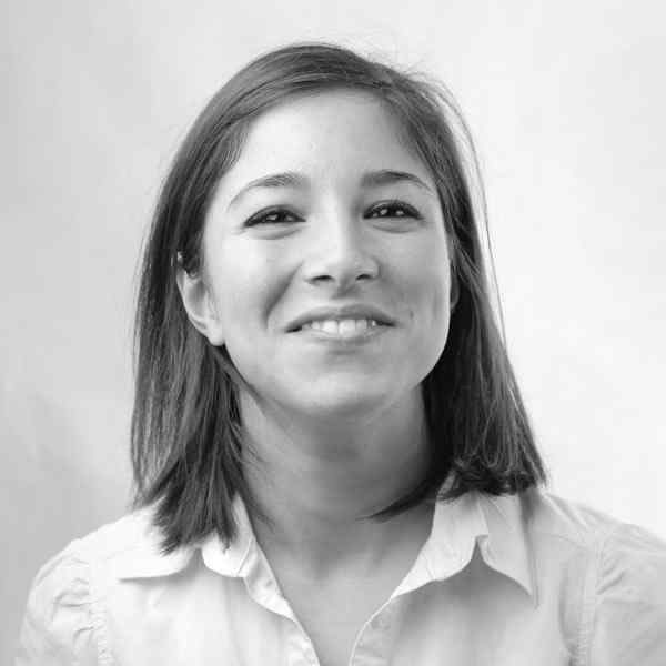 Black and white portrait of a smiling woman with shoulder-length hair.