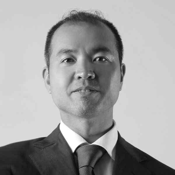 Black and white portrait of a man in a suit and tie.