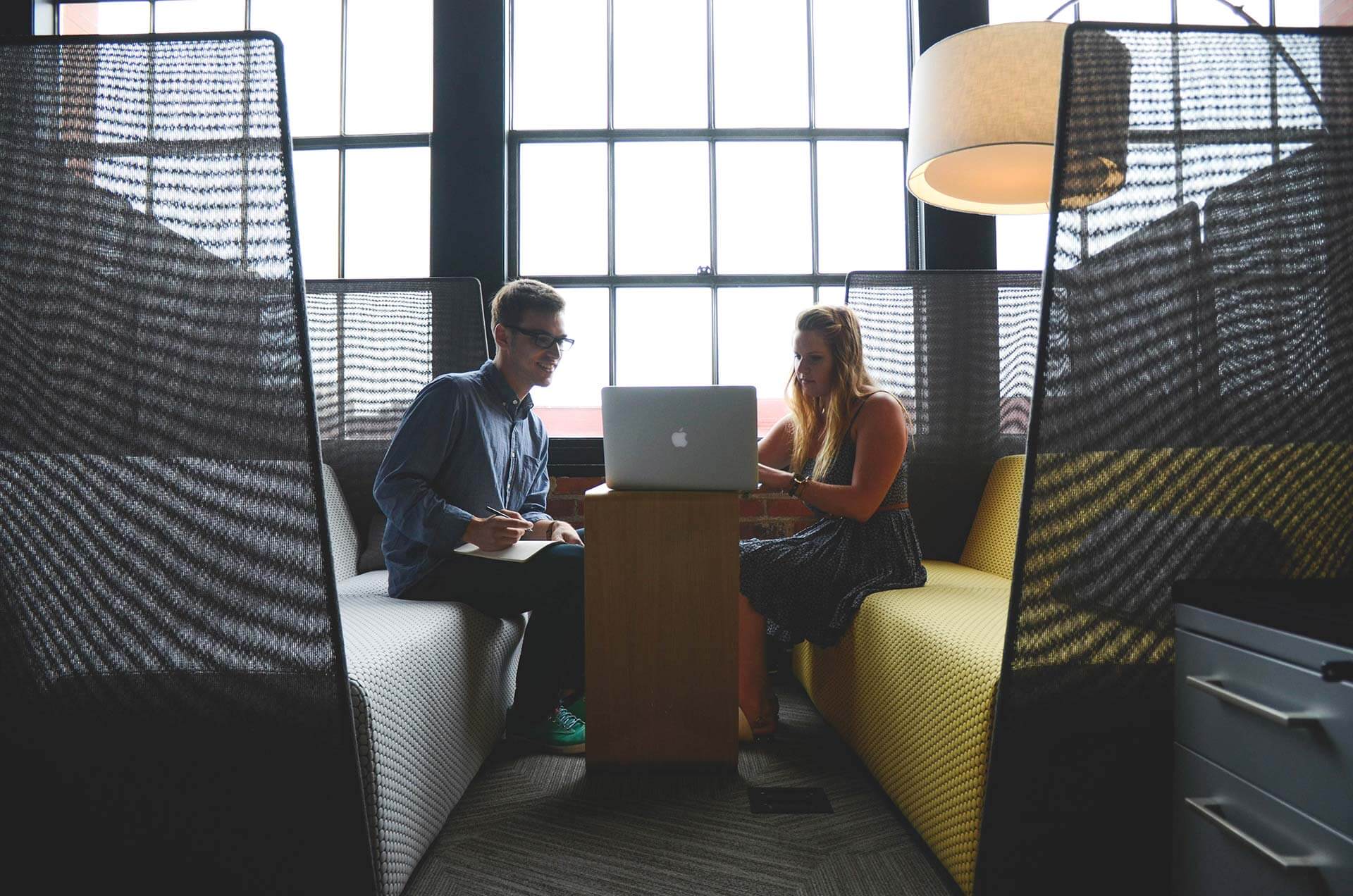 Two people collaborating in modern office space.