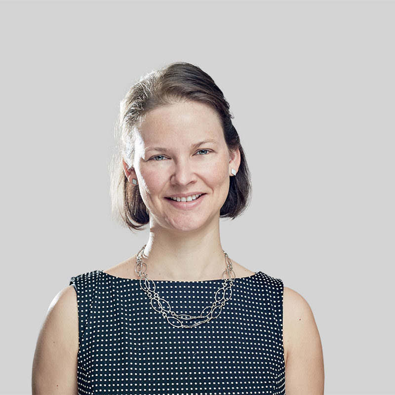 Smiling woman in a polka dot dress.